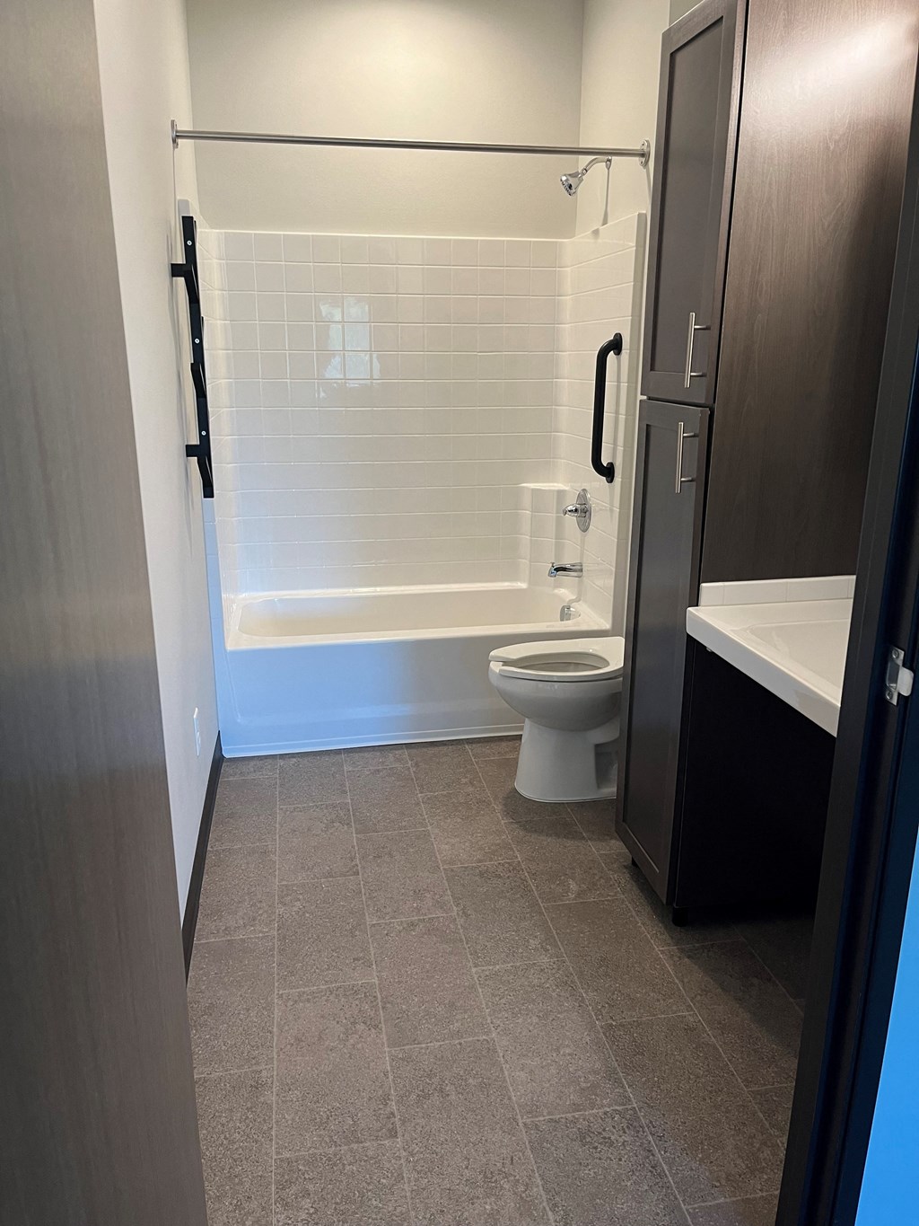 a bathroom with a toilet and a tub and a sink