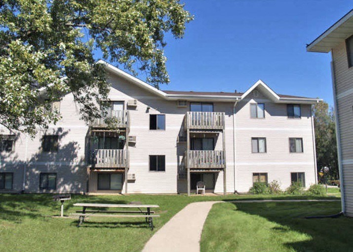 an apartment building with a picnic table in front of it