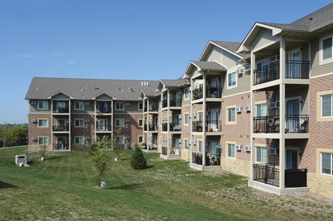 Apartment complex with multiple buildings and balconies.