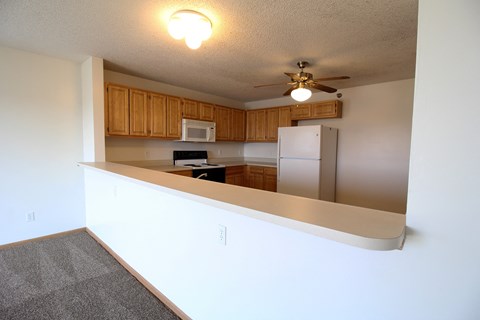 A kitchen with a microwave, oven, and refrigerator.