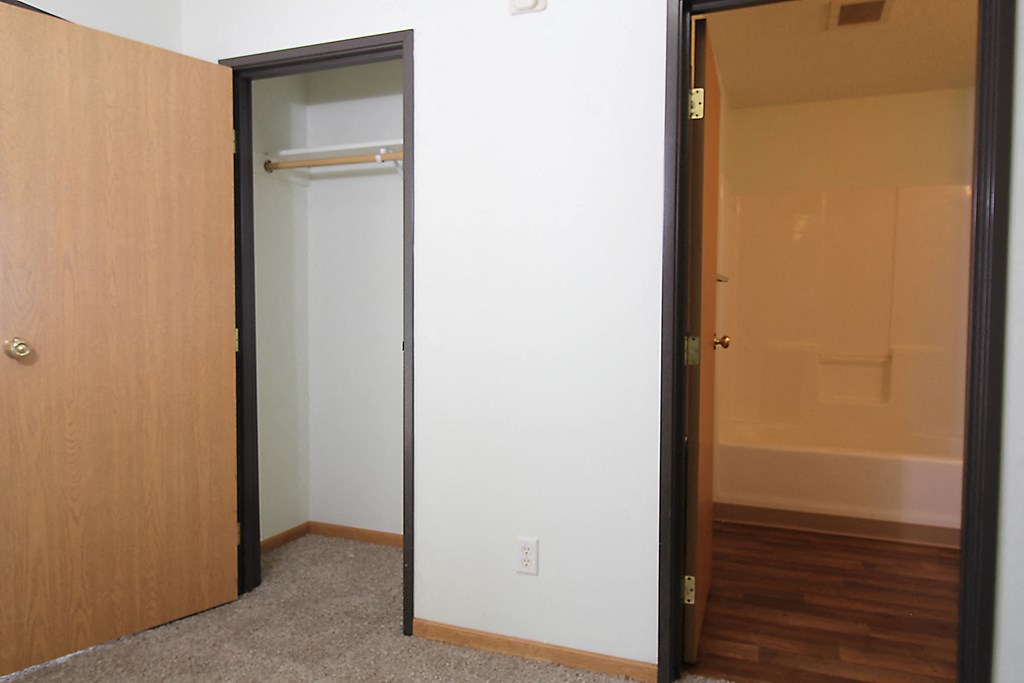 an open door to a bathroom with a shower and bathtub