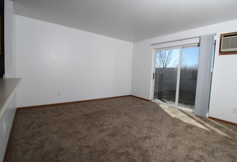 a living room with a door to a balcony