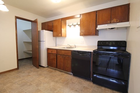 a kitchen with wooden cabinets and black appliances