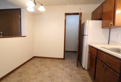 a kitchen with a refrigerator and a sink