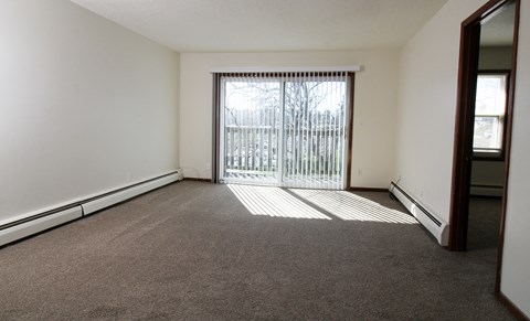 an empty living room with a sliding glass door