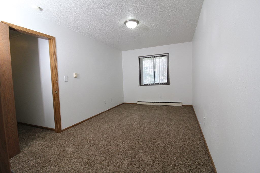 a small empty room with a window and a door