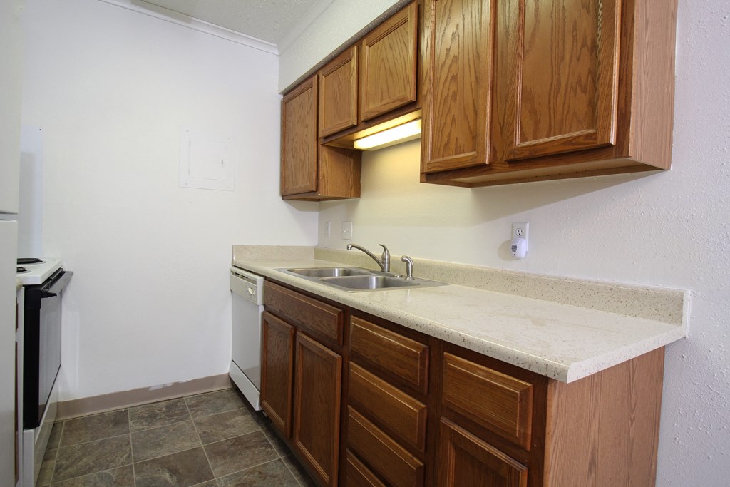 a kitchen with wooden cabinets and a sink