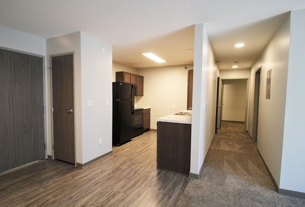 a view of the kitchen and living room in a bedroom apartment