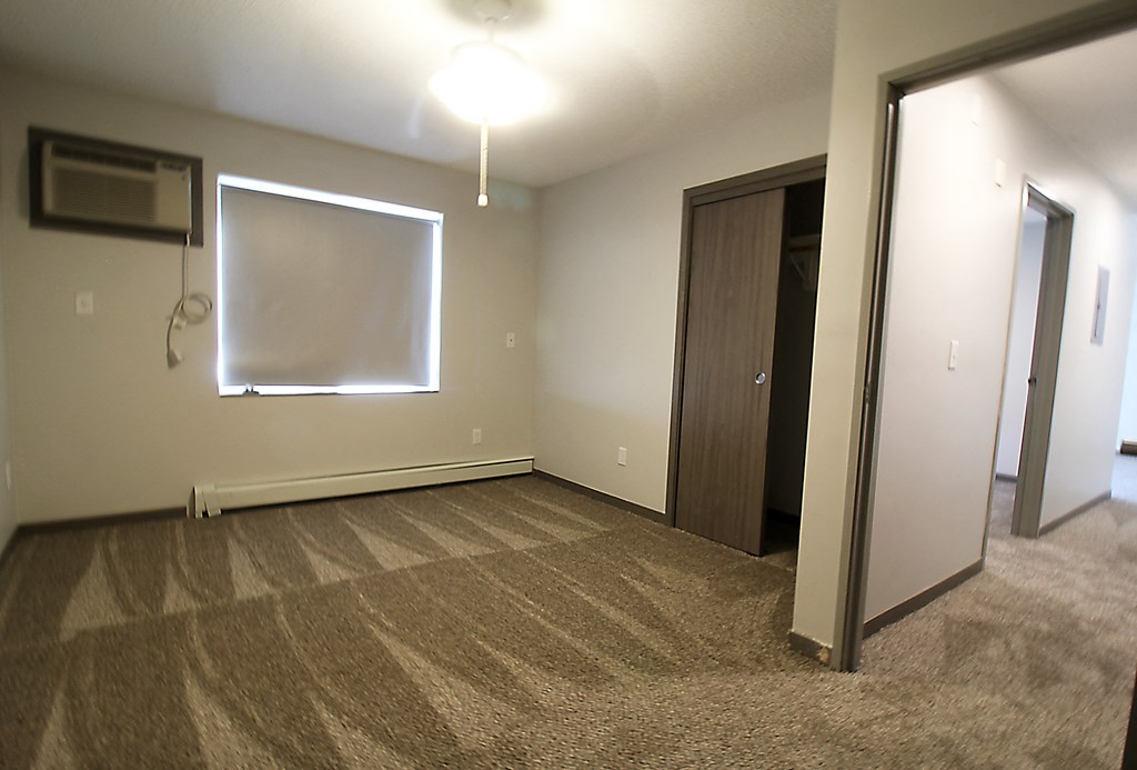 an empty room with a whiteboard on the wall