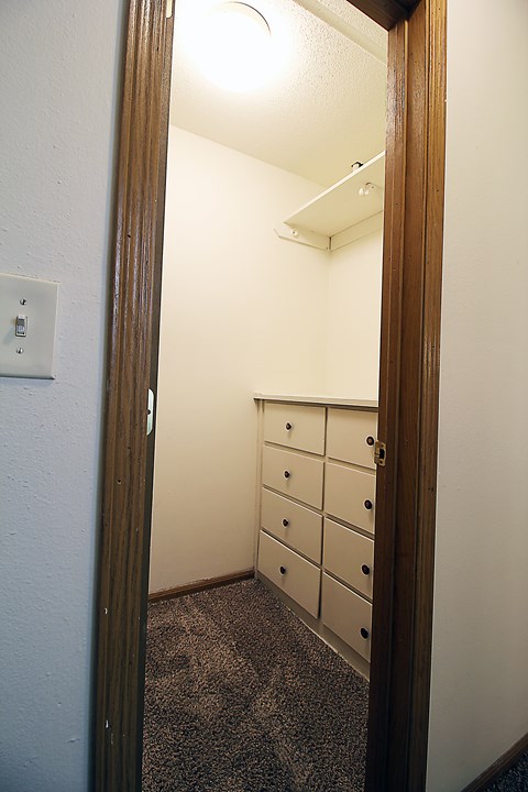 A white door with a light switch on the wall.