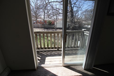 a sliding glass door with a view of the deck