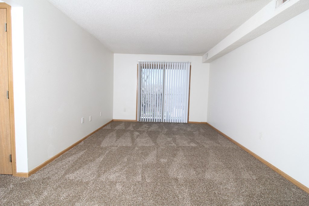 a bedroom with a carpeted floor and white walls