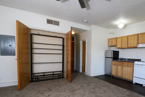 a kitchen with a refrigerator freezer next to a stove top oven