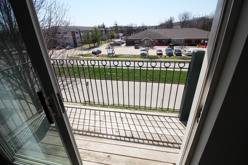 a view of the parking lot from the screened in porch