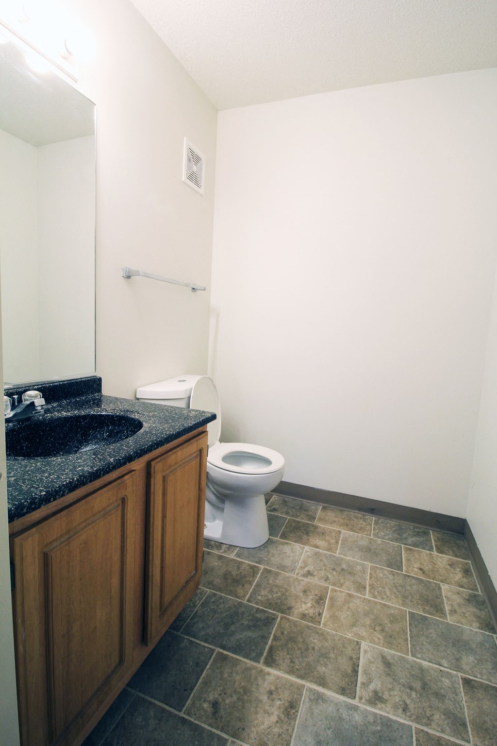 a bathroom with a sink toilet and mirror