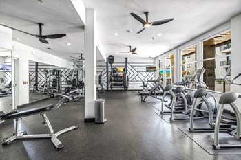 a workout room with a variety of exercise equipment - Photo Gallery 23