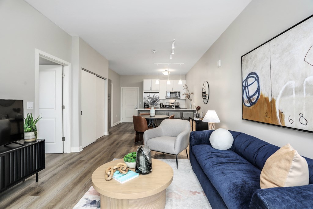 a living room with a blue couch and a coffee table at Beekman on Broadway, Ann Arbor
