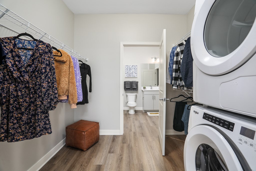 a laundry room with a washer and dryer and a door to a bathroom at Beekman on Broadway, Ann Arbor, MI, 48105