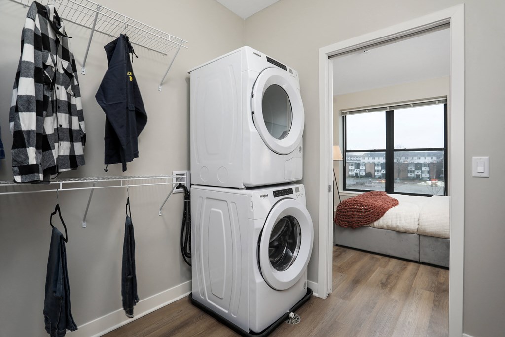 a white washer and dryer in a room with a closet and a window at Beekman on Broadway, Ann Arbor, Michigan