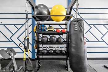 a boxing bag and other equipment on a rack in a gym - Photo Gallery 26