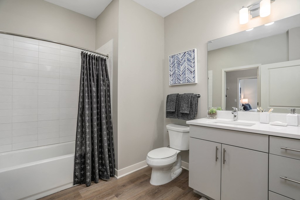 an open bathroom with a shower toilet and sink at Beekman on Broadway, Ann Arbor, MI