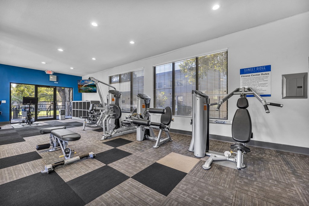 a gym with weights and cardio equipment at the preserve at greatstone  at Sunset Ridge, San Antonio, TX