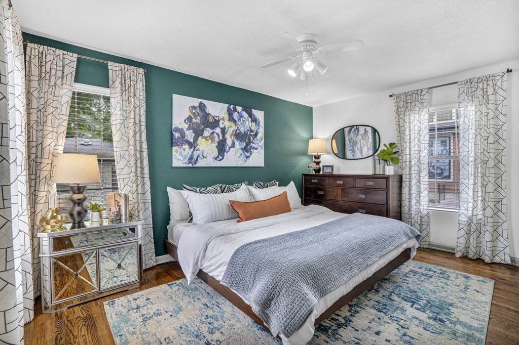 a bedroom with green walls and a white bed a bedroom with green walls and a white bed at Sunset Ridge, Texas, 78209