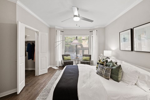 Modern bedroom with walk-in closet and reading nook at Nalle Woods of Westlake Apartments, Austin, 78746