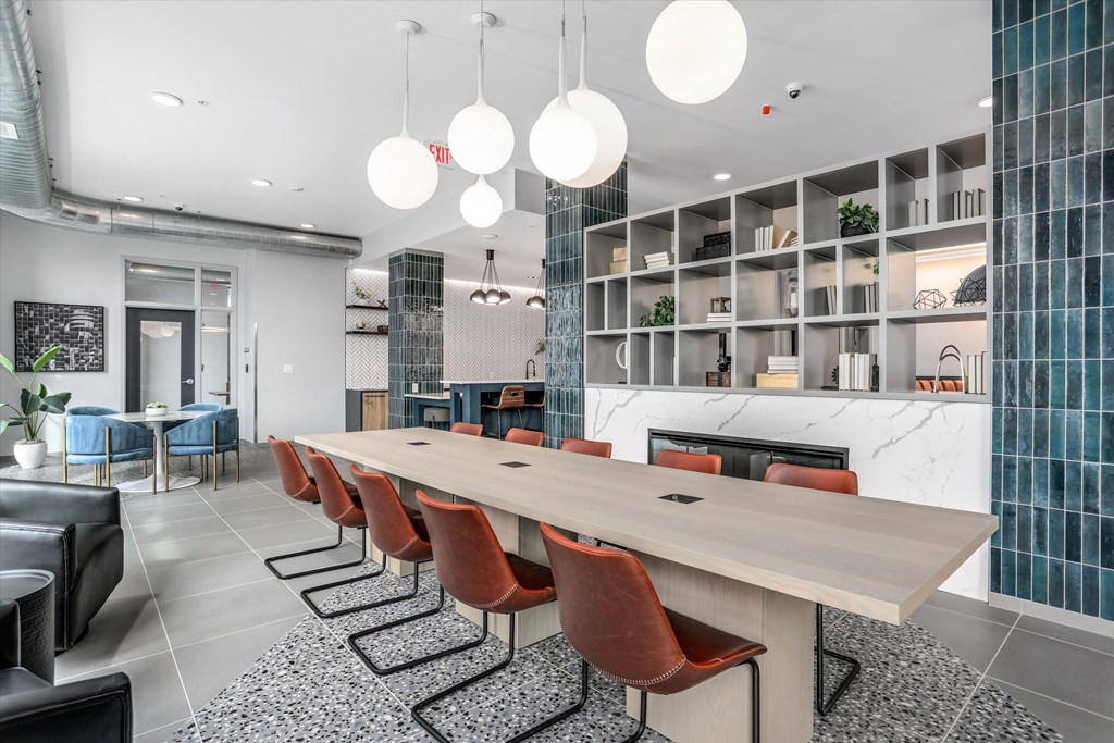 a dining room with a long wooden table and chairs at Beekman on Broadway, Ann Arbor