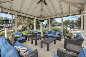 a covered patio with couches and tables  at Sunset Ridge, Texas, 78209