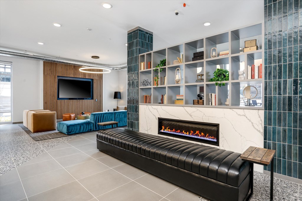 a living room with a fireplace and a tv at Beekman on Broadway, Ann Arbor, Michigan