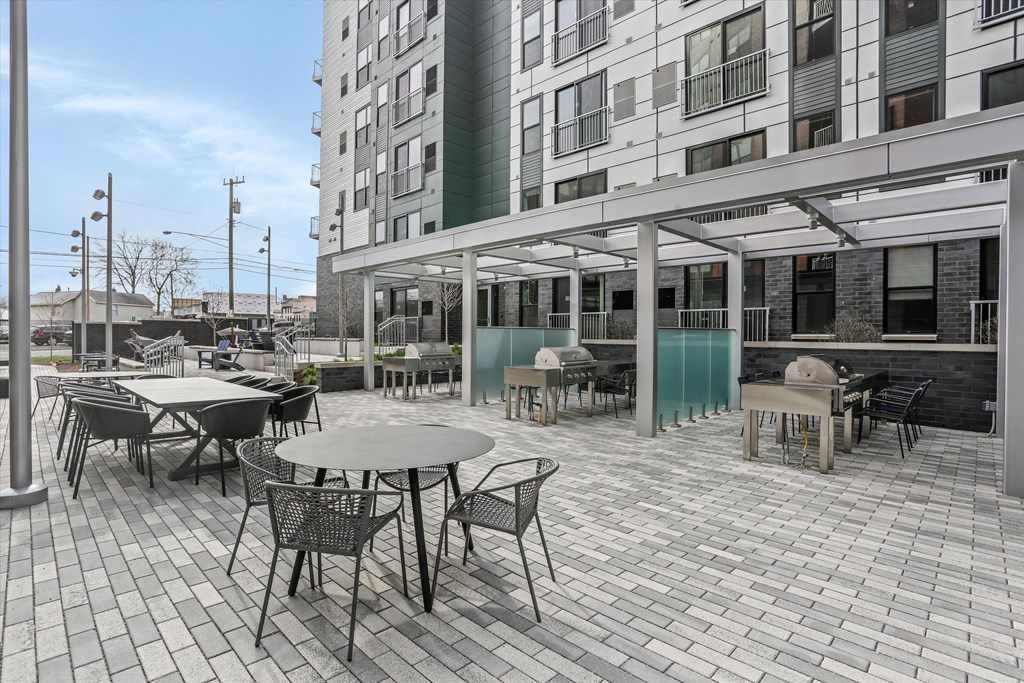 a patio with tables and chairs outside of a building at Beekman on Broadway, Ann Arbor, MI