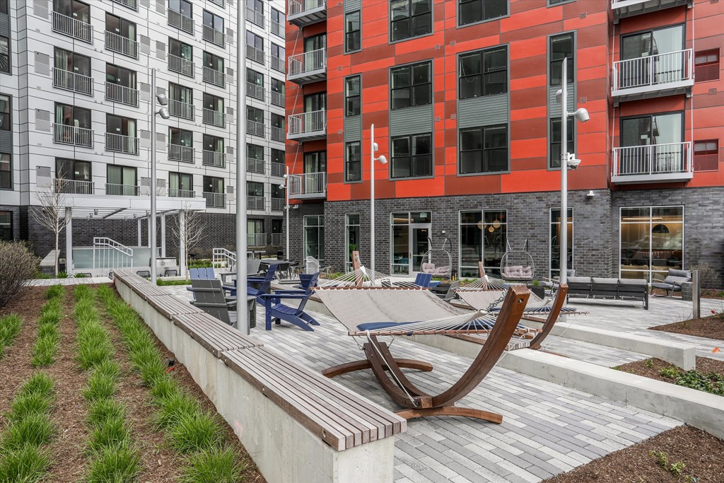 courtyard with lounge chairs and hammocks at the district flats apartments at Beekman on Broadway, Ann Arbor, Michigan