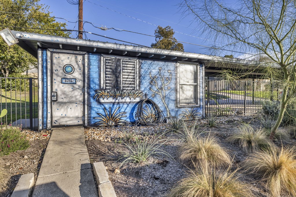 an old blue shack with graffiti on the side of it  at Sunset Ridge, San Antonio, TX, 78209