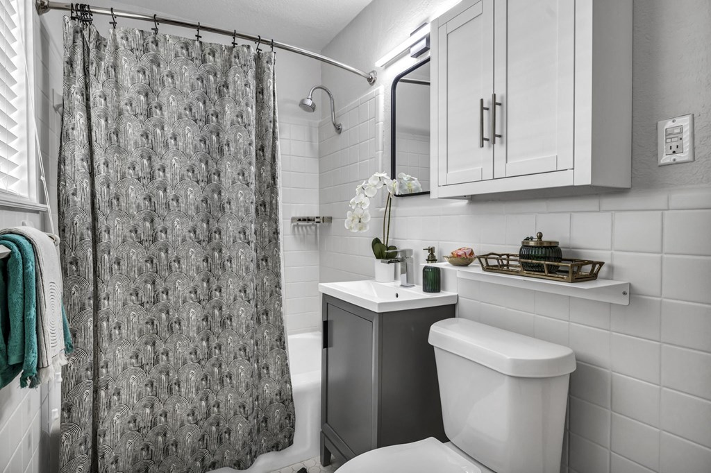 a bathroom with a white toilet next to a shower with a curtain  at Sunset Ridge, San Antonio, 78209