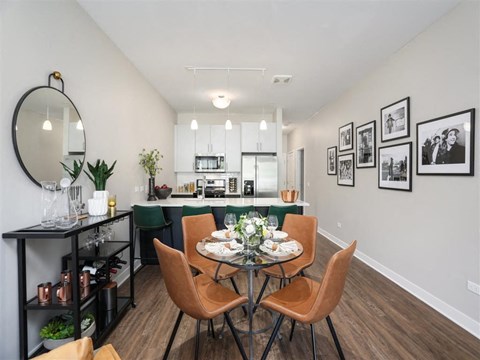 A dining room with a table set for a meal.