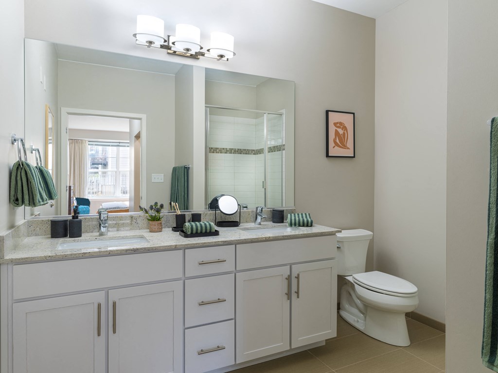 a bathroom with white cabinets and a large mirror  at Elmhurst 255, Elmhurst