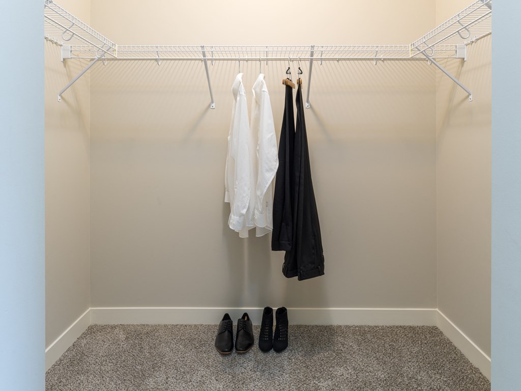 a walk in closet with a coat rack and a pair of shoes on the floor  at Elmhurst 255, Elmhurst, IL, 60126