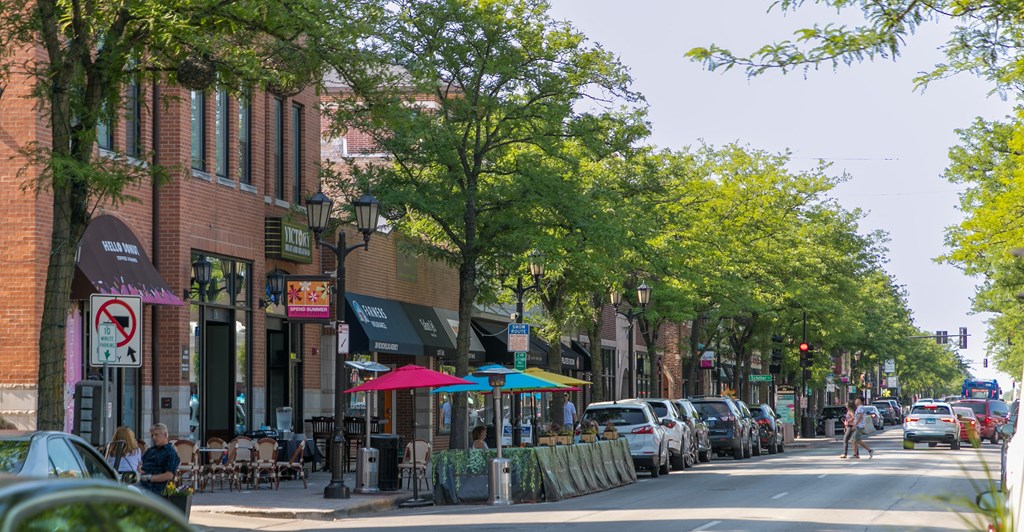 a city street lined with brick buildings and trees  at Elmhurst 255, Elmhurst, IL