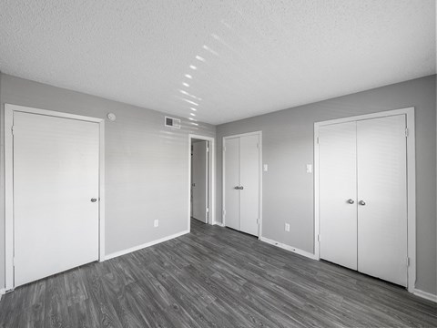 the living room of an empty apartment with white doors