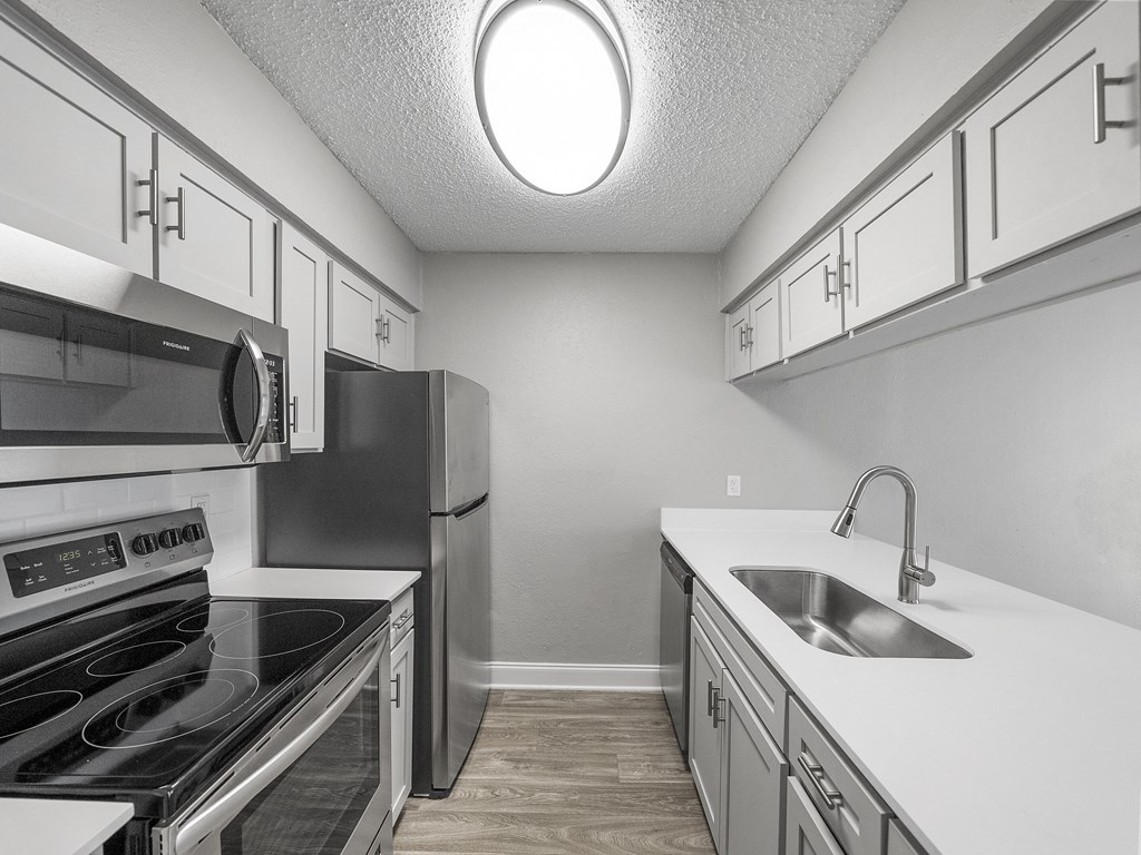 Kitchen with stainless steel appliances at The Stella, Irving, Texas