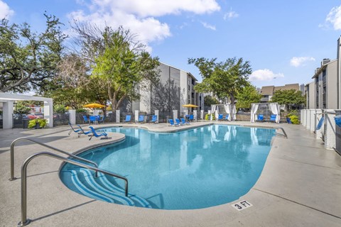 A large swimming pool with a metal ladder on the side.
