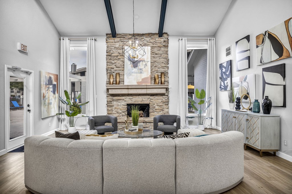 a living room with a large couch and a stone fireplace