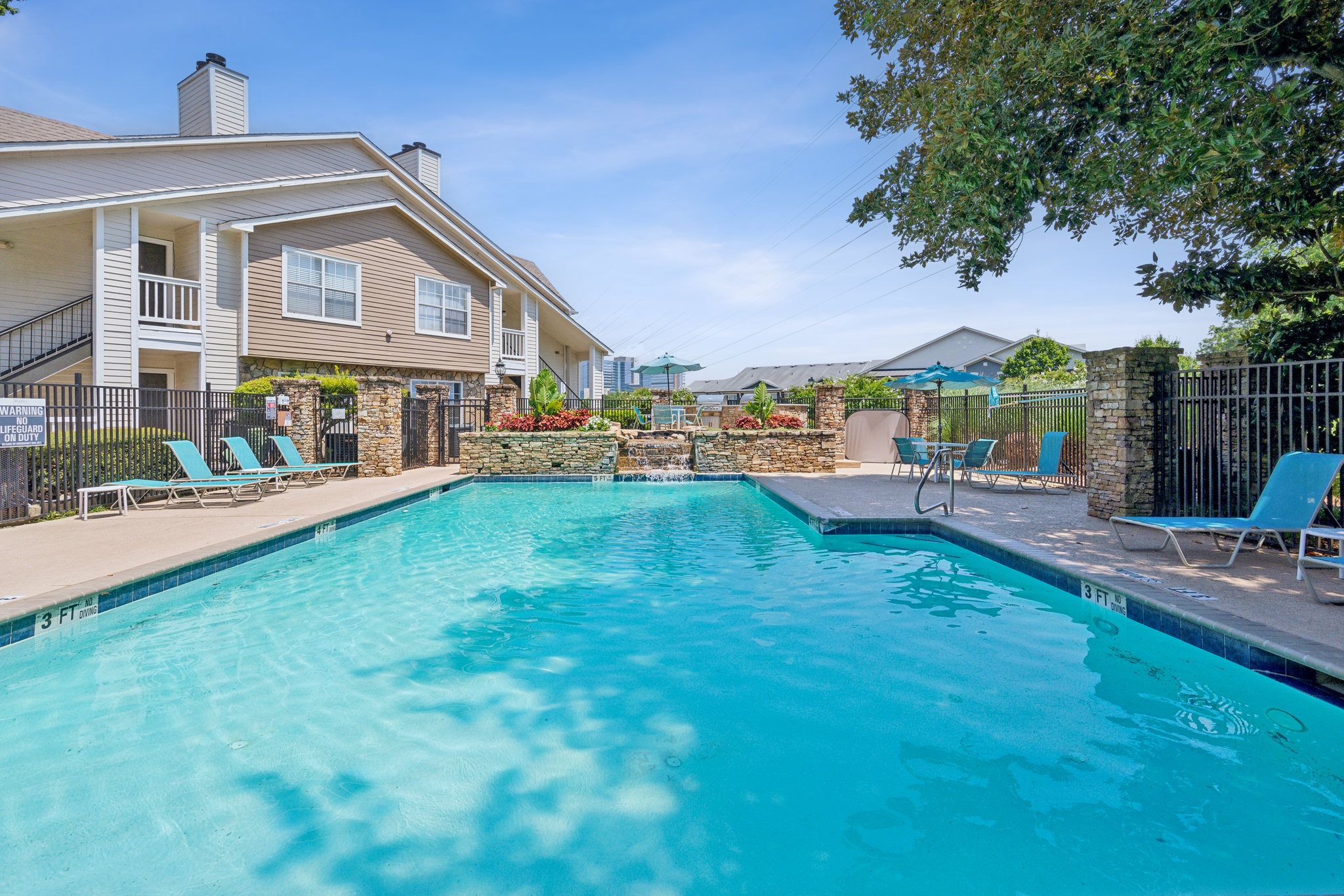 A swimming pool in front of a residential building.