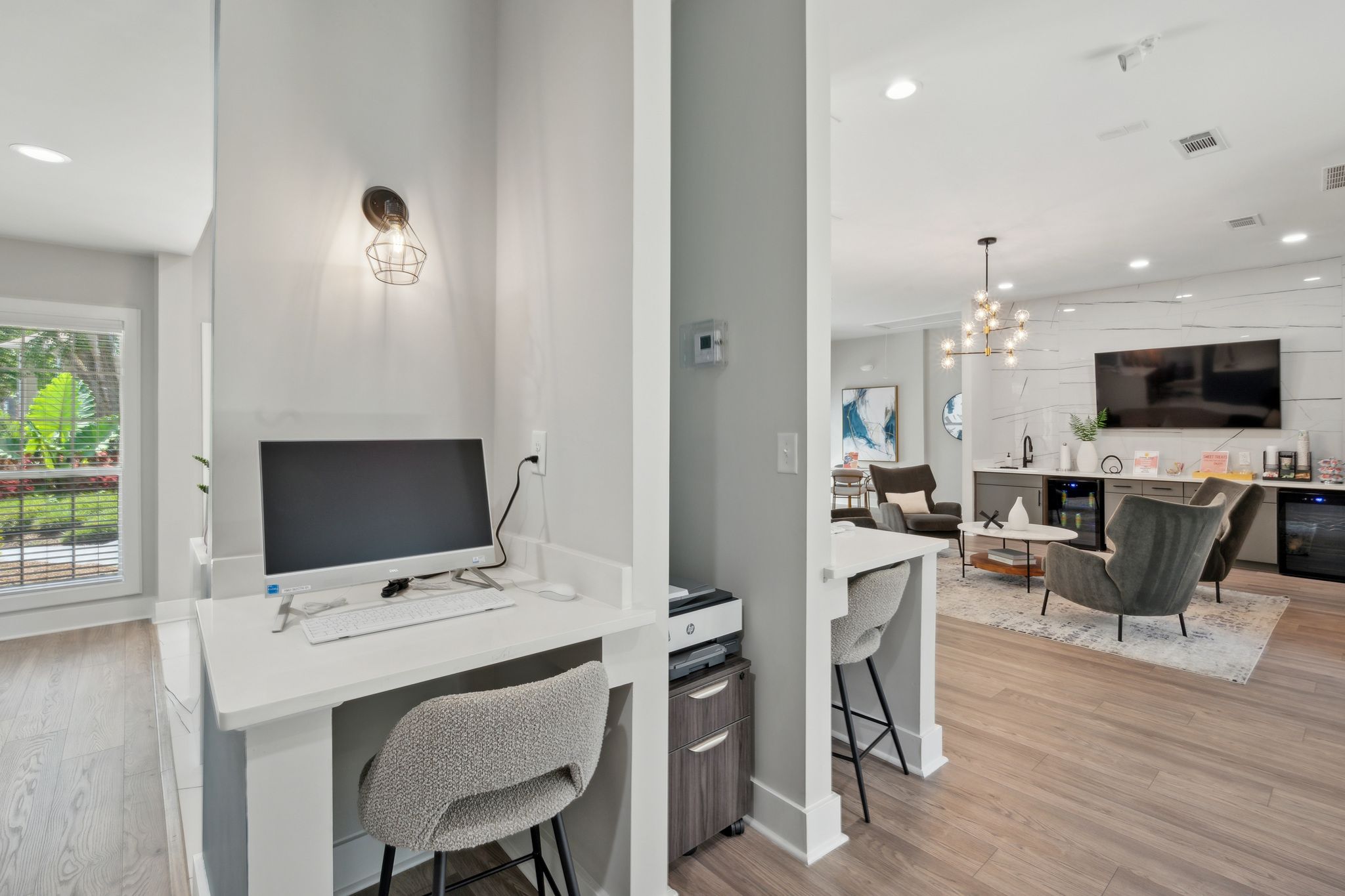 A modern home office with a desk, chair, and computer setup.