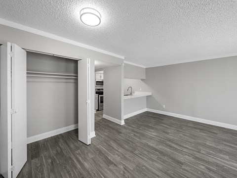 the spacious living room and kitchen in a new home with wood flooring