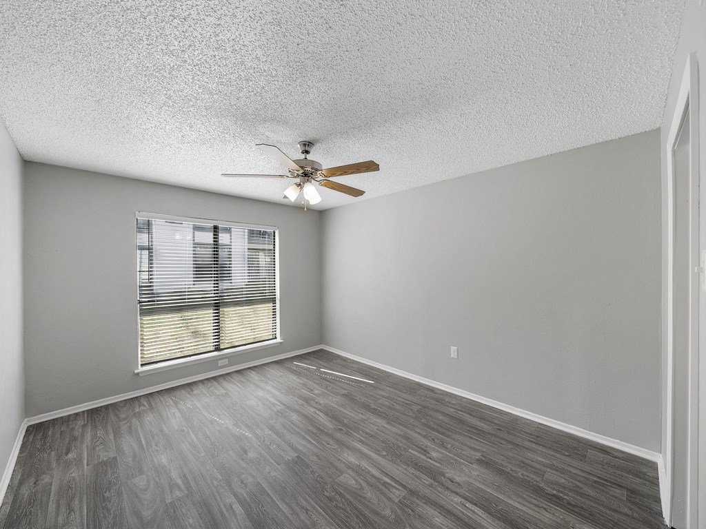 Room with ceiling fan and oversized window at The Stella, Irving