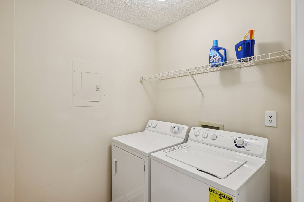 A small laundry room with a washer and dryer.