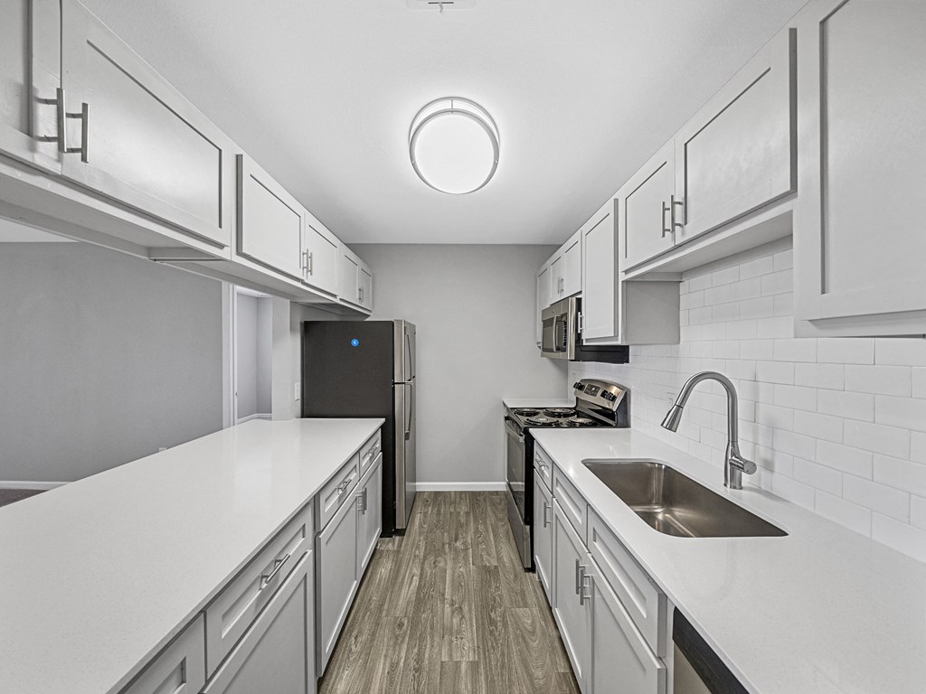 the preserve at ballantyne commons apartment kitchen with white cabinets and a sink
