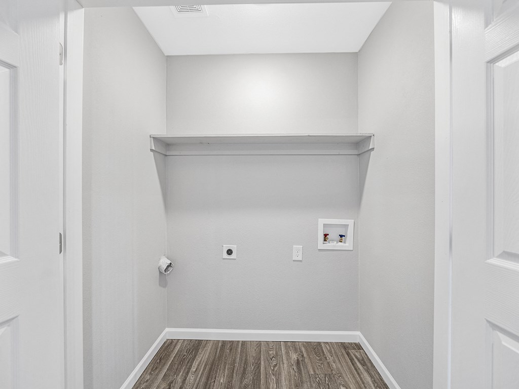 an empty room with white walls and wood flooring and a white wall with a